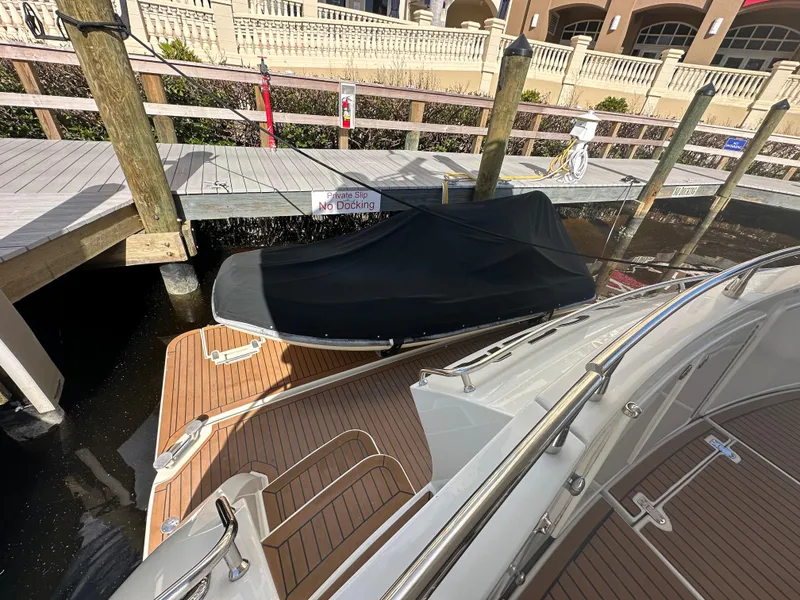Slide: The Image of 2004 Marquis 59 yacht docked with covered boat on deck. - 7