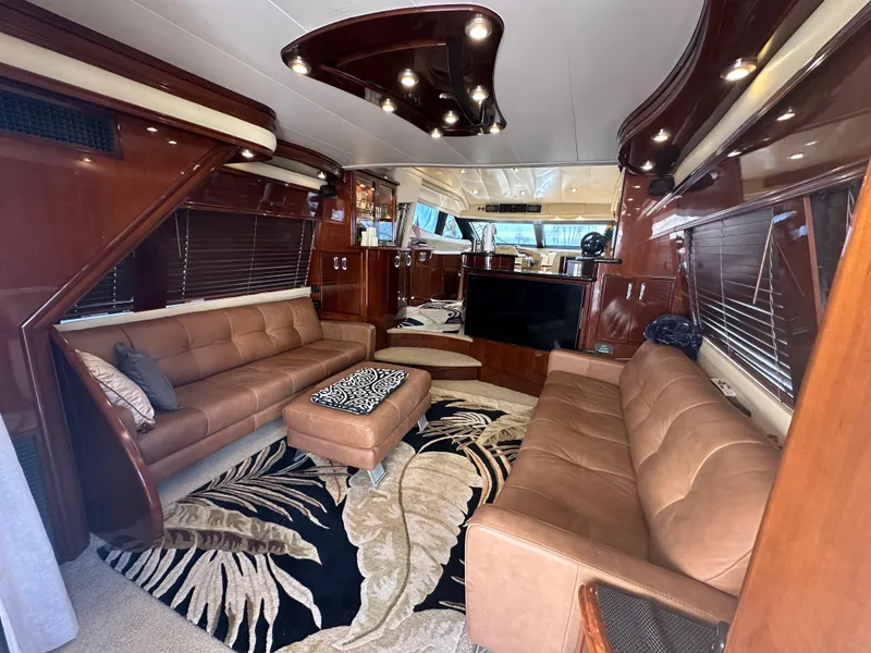 Slide: The Image of Luxurious 2004 Marquis 59 yacht interior with leather sofas and elegant wood finishes. - 9