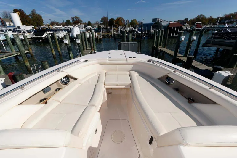 Slide: The Image of 2015 Grady-White Freedom 335 boat interior with spacious seating at a marina. - 12