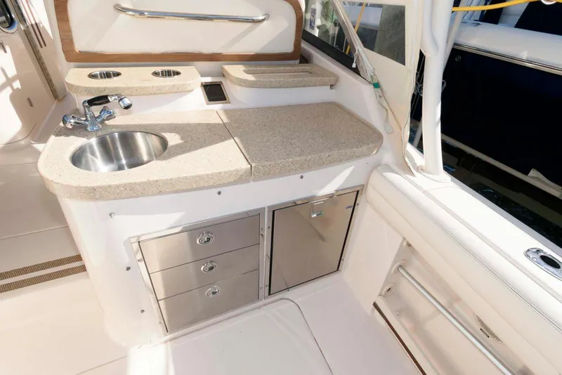 Slide: The Image of 2015 Grady-White Freedom 335 boat interior with kitchenette and storage drawers. - 15