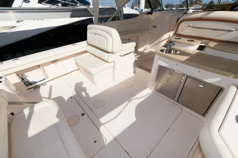 Slide: The Image of 2015 Grady-White Freedom 335 boat interior with seating and storage compartments. - 18