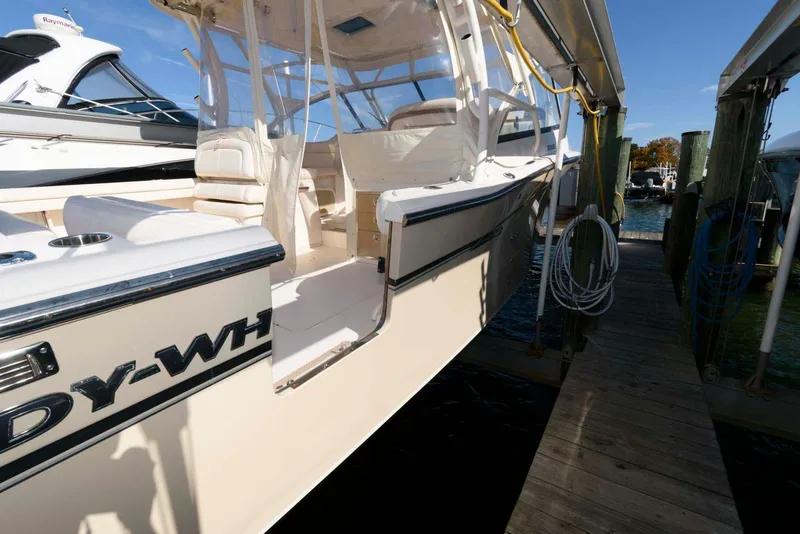 Slide: The Image of 2015 Grady-White Freedom 335 boat docked, showcasing sleek design and spacious interior. - 20