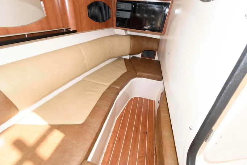 Slide: The Image of Interior of 2015 Grady-White Freedom 335 boat with cushioned seating and wood flooring. - 21