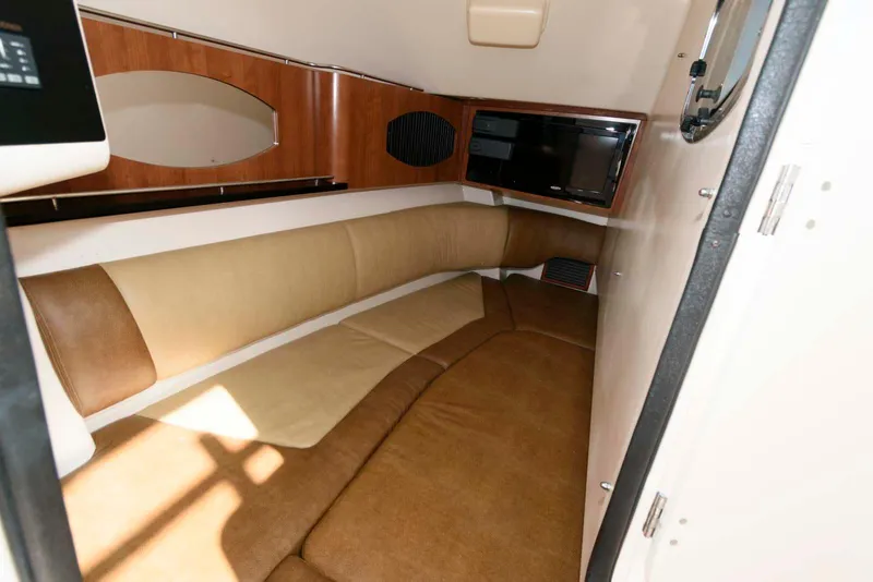 Slide: The Image of 2015 Grady-White Freedom 335 cabin interior with beige seating and wood accents. - 22