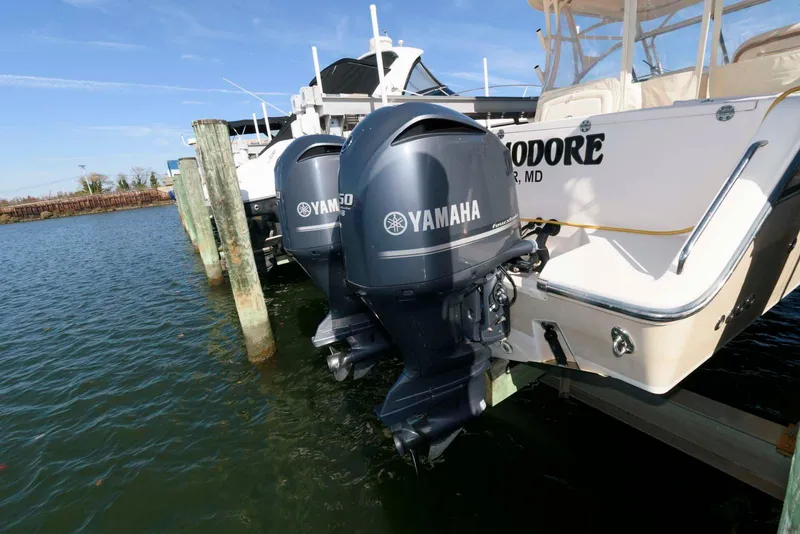 Slide: The Image of 2015 Grady-White Freedom 335 boat with Yamaha outboard motors docked in water. - 26