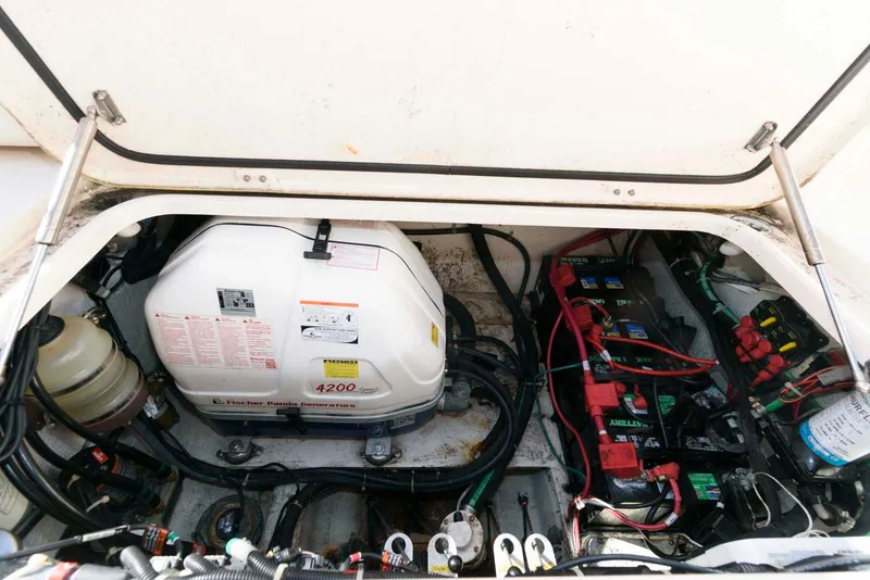 Slide: The Image of Engine compartment of 2015 Grady-White Freedom 335 boat, showing generator and battery setup. - 27