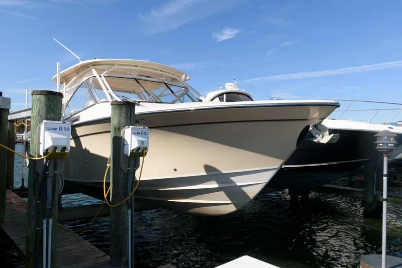 Slide: The Image of 2015 Grady-White Freedom 335 boat docked, showcasing sleek design and sturdy build. - 4