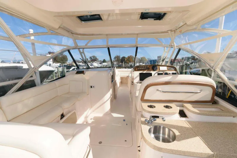 Slide: The Image of Interior of 2015 Grady-White Freedom 335 boat with seating and helm. - 5