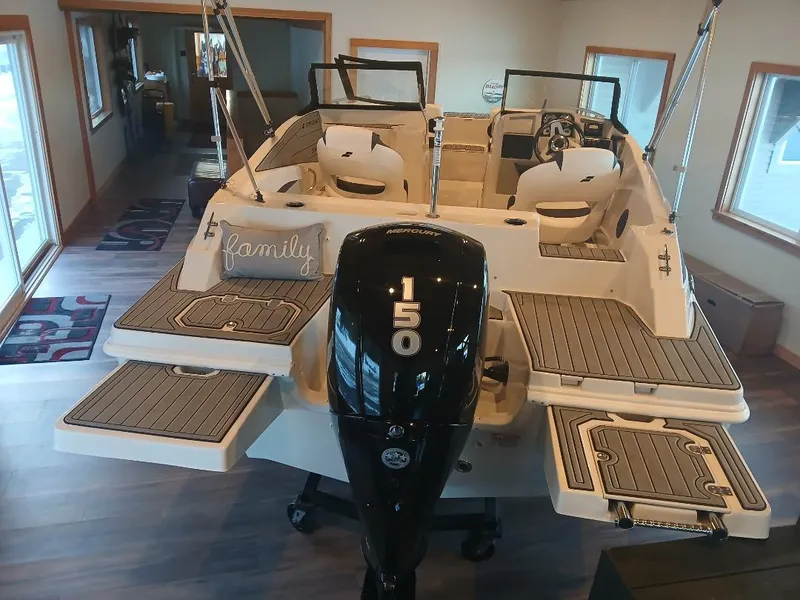 Slide: The Image of 2025 Starcraft SVX 190 OB boat with 150 HP engine, displayed indoors. - 1