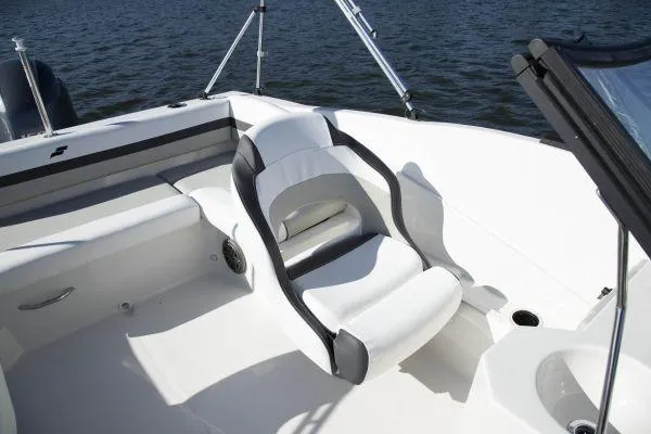 Slide: The Image of 2025 Starcraft SVX 190 OB boat interior with white seating and water in the background. - 6