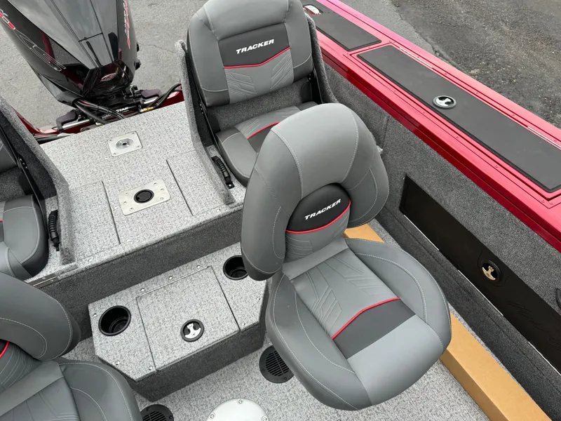 Slide: The Image of 2024 Tracker Targa V-18 Combo boat interior with gray and red seating. - 11