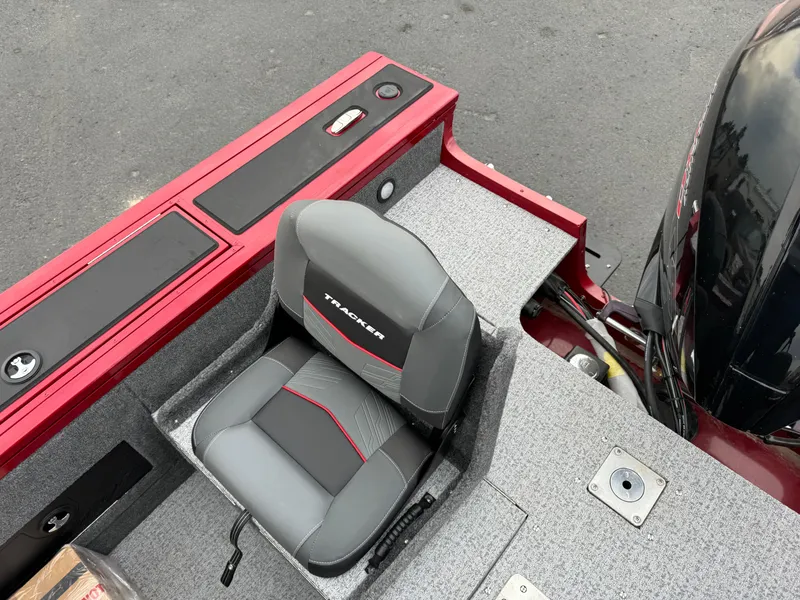 Slide: The Image of 2024 Tracker Targa V-18 Combo boat interior with gray seat and red accents. - 12