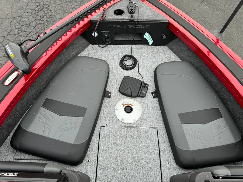 Slide: The Image of 2024 Tracker Targa V-18 Combo boat interior with two seats and fishing equipment. - 15