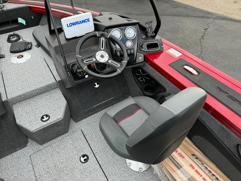 Slide: The Image of 2024 Tracker Targa V-18 Combo boat interior with steering wheel and Lowrance display. - 8