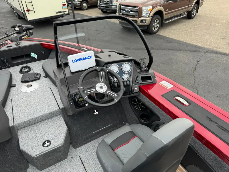 Slide: The Image of 2024 Tracker Targa V-18 Combo boat interior with steering wheel and Lowrance display. - 9
