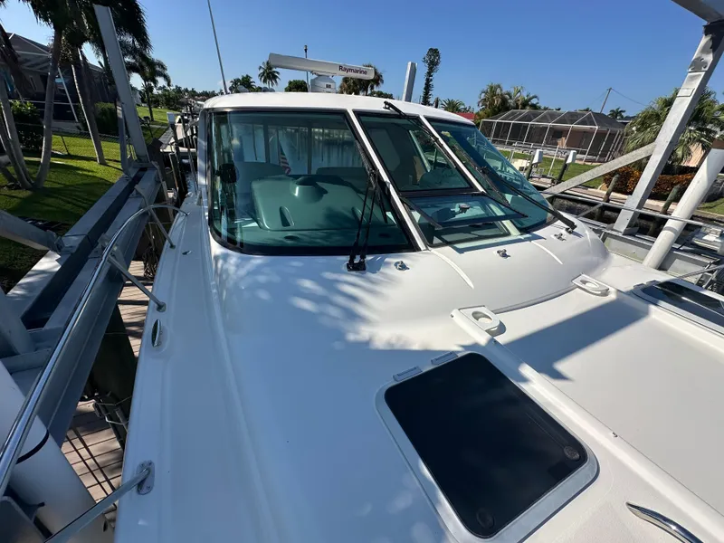 Slide: The Image of 2005 Tiara Yachts 3600 Sovran docked, showcasing sleek design and spacious deck. - 11