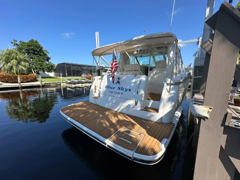 Slide: The Image of 2005 Tiara Yachts 3600 Sovran docked, rear view with American flag. - 14