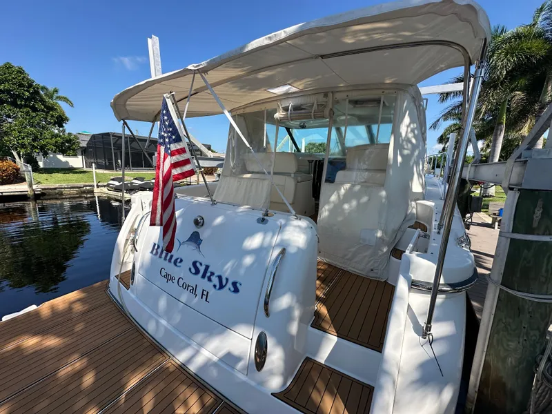 Slide: The Image of 2005 Tiara Yachts 3600 Sovran docked, featuring "Blue Skys" and American flag, Cape Coral, FL. - 15