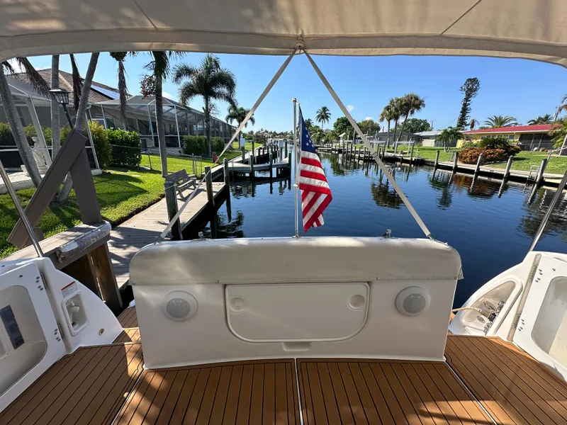 Slide: The Image of 2005 Tiara Yachts 3600 Sovran docked, featuring teak deck and American flag. - 17