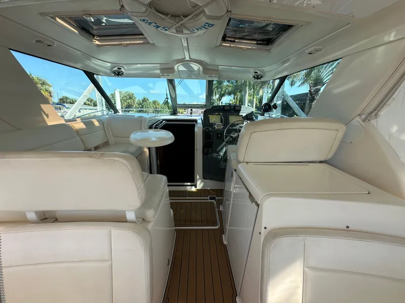 Slide: The Image of 2005 Tiara Yachts 3600 Sovran interior with white seating and wooden flooring. - 18