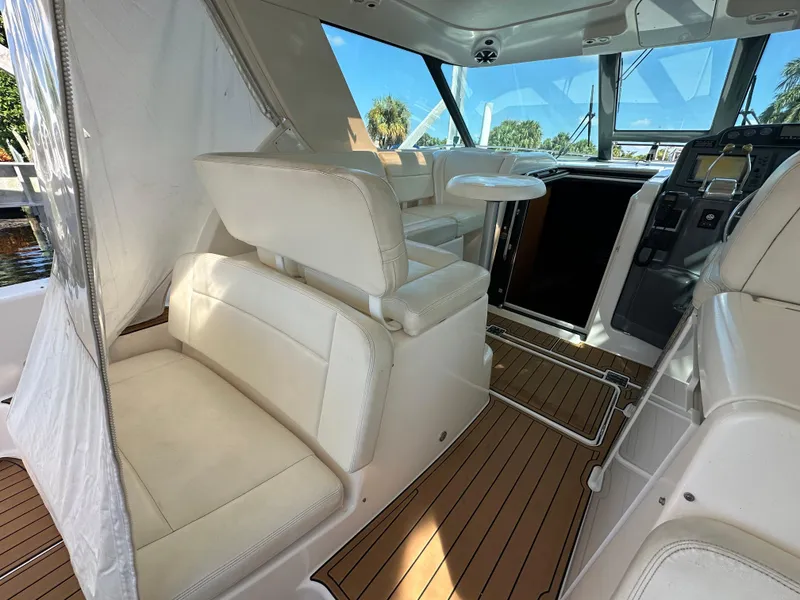 Slide: The Image of 2005 Tiara Yachts 3600 Sovran interior with white seating and wood flooring. - 19