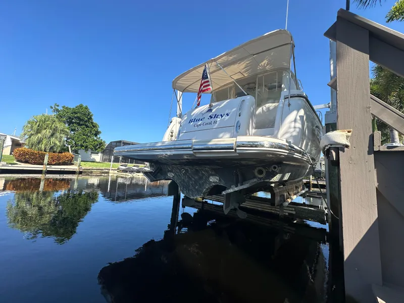 Slide: The Image of 2005 Tiara Yachts 3600 Sovran docked, rear view with American flag, sunny day. - 2