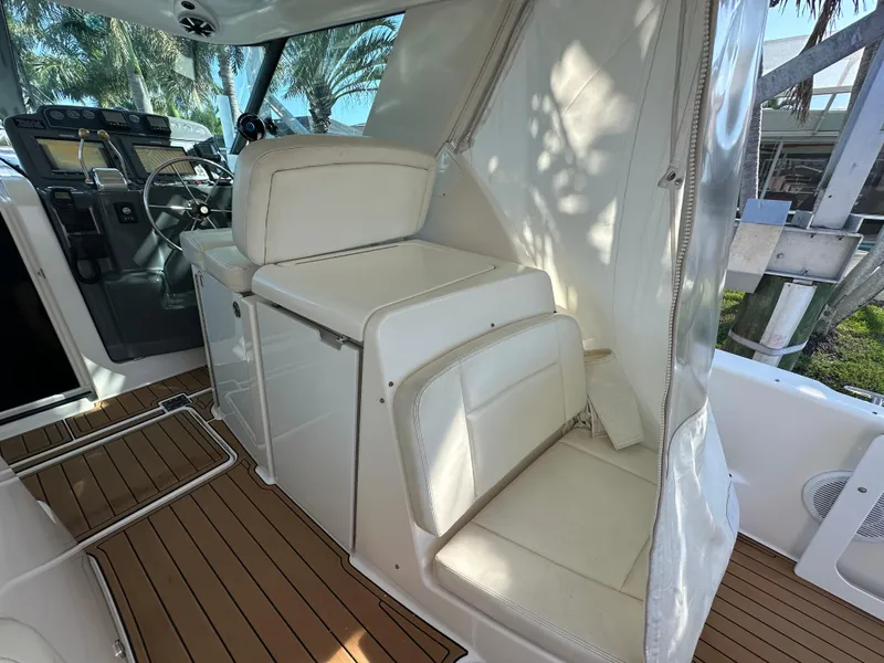 Slide: The Image of 2005 Tiara Yachts 3600 Sovran interior with white seating and wooden flooring. - 20