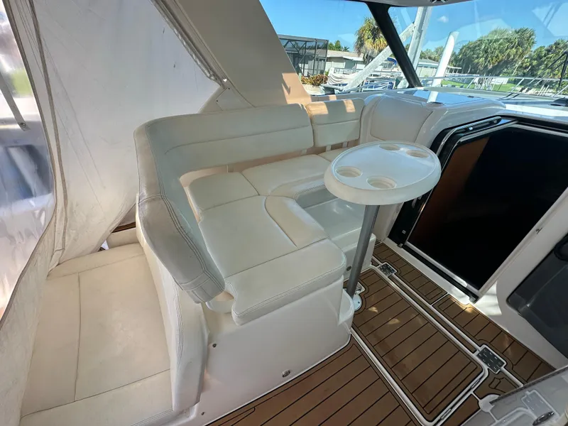 Slide: The Image of 2005 Tiara Yachts 3600 Sovran interior with white seating and wooden flooring. - 22