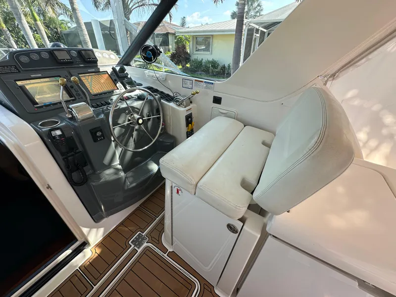 Slide: The Image of 2005 Tiara Yachts 3600 Sovran helm with steering wheel and navigation controls. - 23