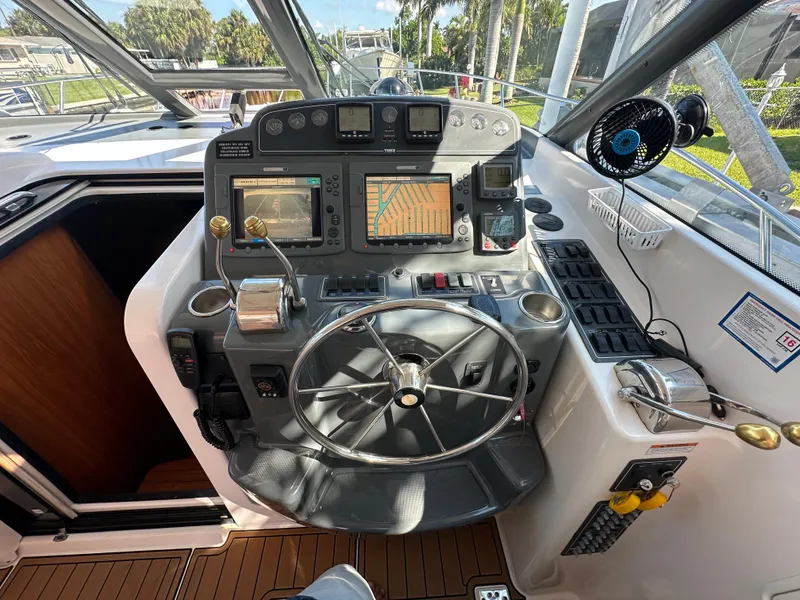 Slide: The Image of 2005 Tiara Yachts 3600 Sovran helm with navigation equipment and steering wheel. - 24