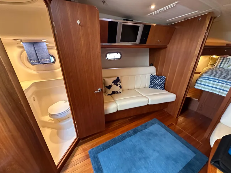 Slide: The Image of 2005 Tiara Yachts 3600 Sovran interior with sofa, bathroom, and bed. - 28