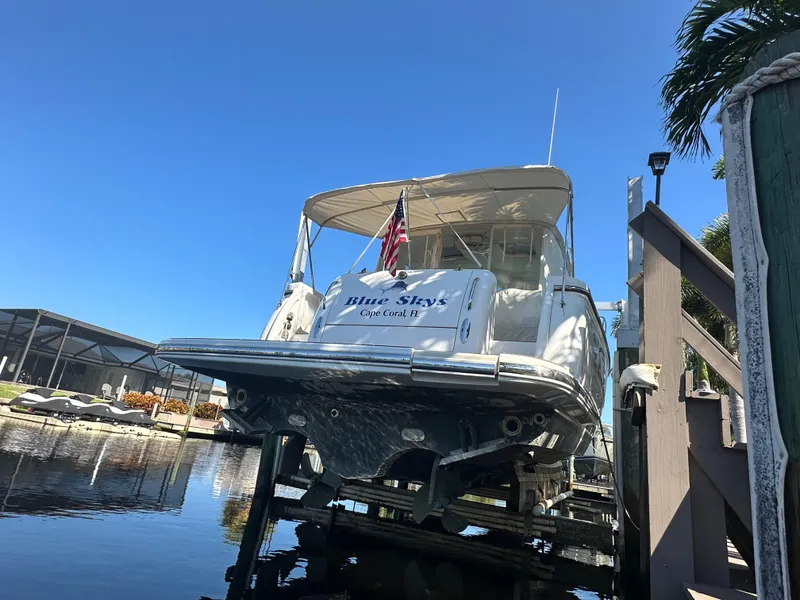 Slide: The Image of 2005 Tiara Yachts 3600 Sovran docked, rear view with American flag. - 3