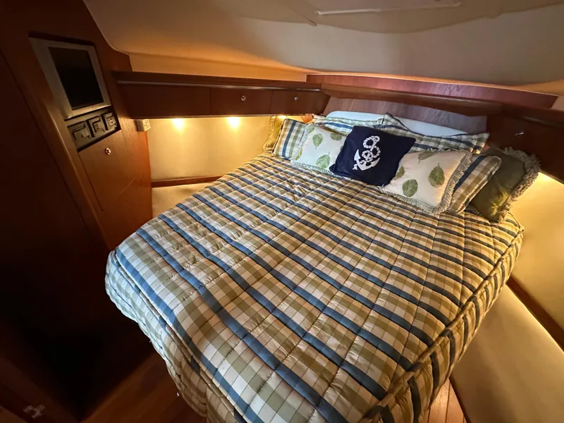 Slide: The Image of Cozy cabin interior of 2005 Tiara Yachts 3600 Sovran with plaid bedding and nautical decor. - 31