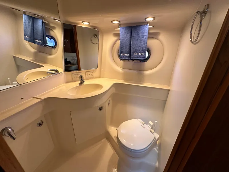 Slide: The Image of Luxurious bathroom in 2005 Tiara Yachts 3600 Sovran with modern fixtures and porthole window. - 36