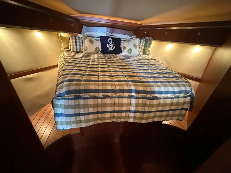 Slide: The Image of Cozy cabin interior of 2005 Tiara Yachts 3600 Sovran with plaid bedding and ambient lighting. - 44