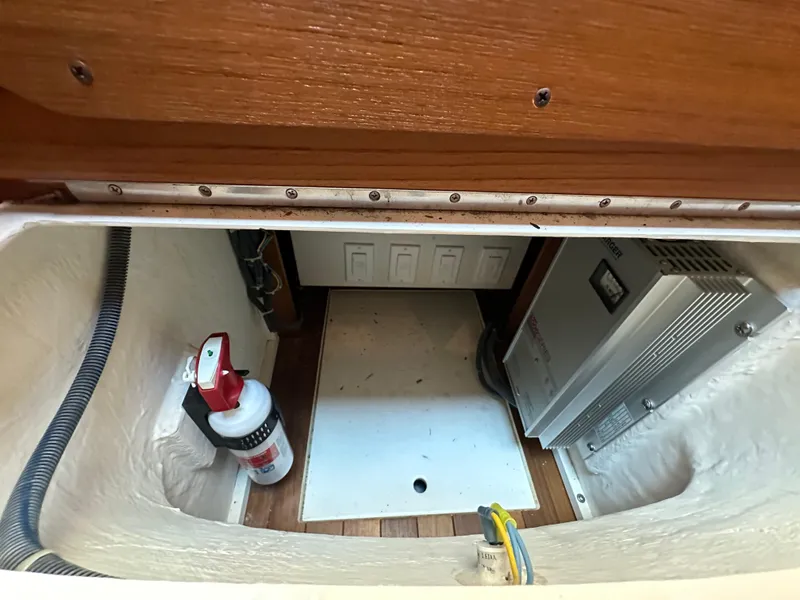 Slide: The Image of 2005 Tiara Yachts 3600 Sovran storage compartment with fire extinguisher and electrical equipment. - 47