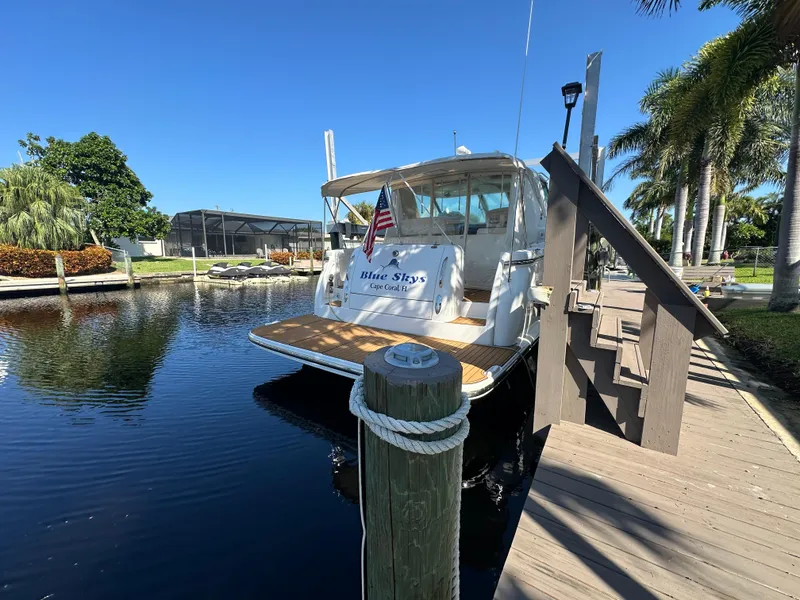 Slide: The Image of 2005 Tiara Yachts 3600 Sovran docked by palm trees and clear blue sky. - 6