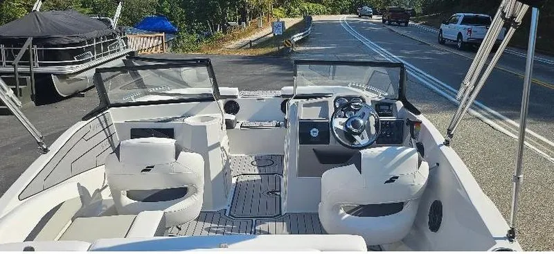 Slide: The Image of 2025 Starcraft SVX 210 DC boat interior with dual consoles and seating. - 2
