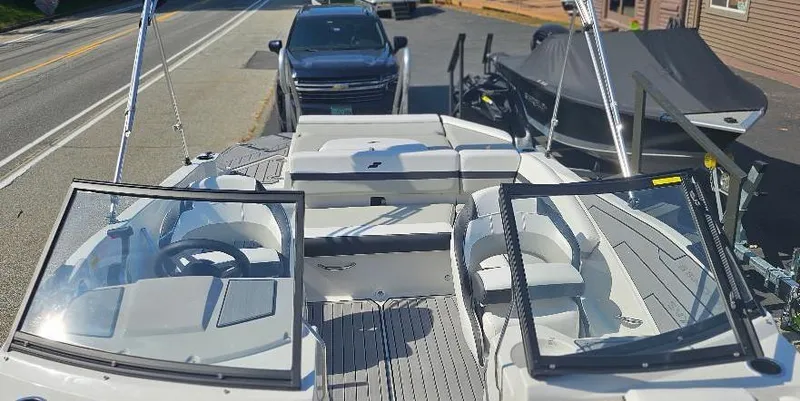 Slide: The Image of 2025 Starcraft SVX 210 DC boat with dual consoles, parked near a road. - 5