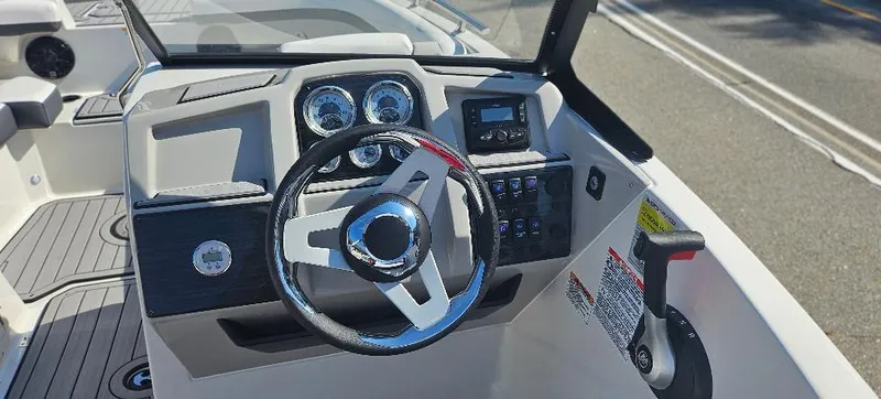 Slide: The Image of 2025 Starcraft SVX 210 DC boat dashboard with steering wheel and control panel. - 6