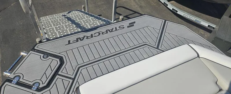 Slide: The Image of 2025 Starcraft SVX 210 DC boat deck with textured flooring and seating. - 9