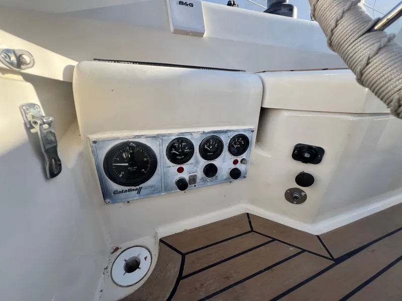 Slide: The Image of 1983 O'Day 34 sailboat cockpit with control panel and gauges. - 13