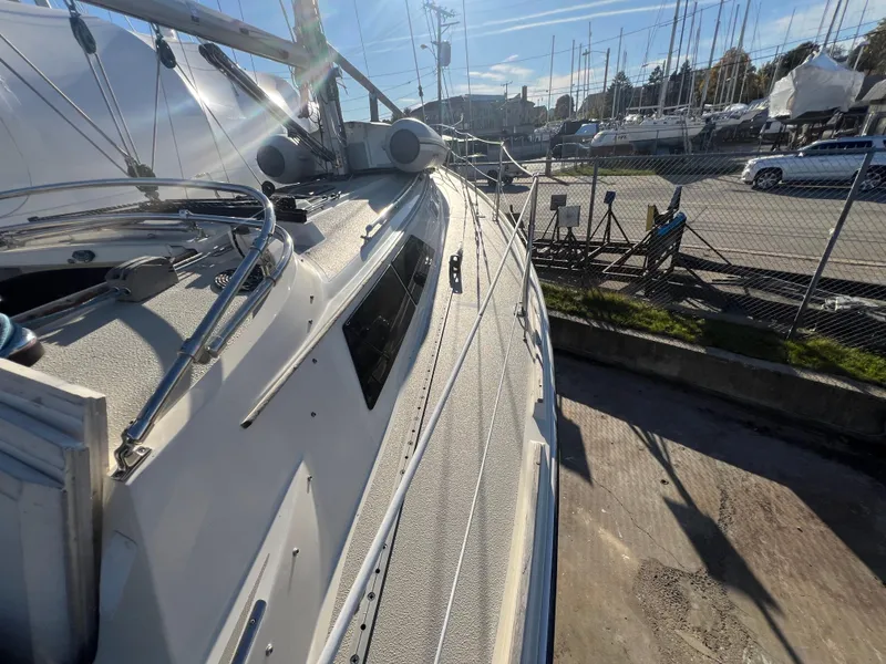 Slide: The Image of 1983 O'Day 34 sailboat docked in a marina under clear skies. - 16