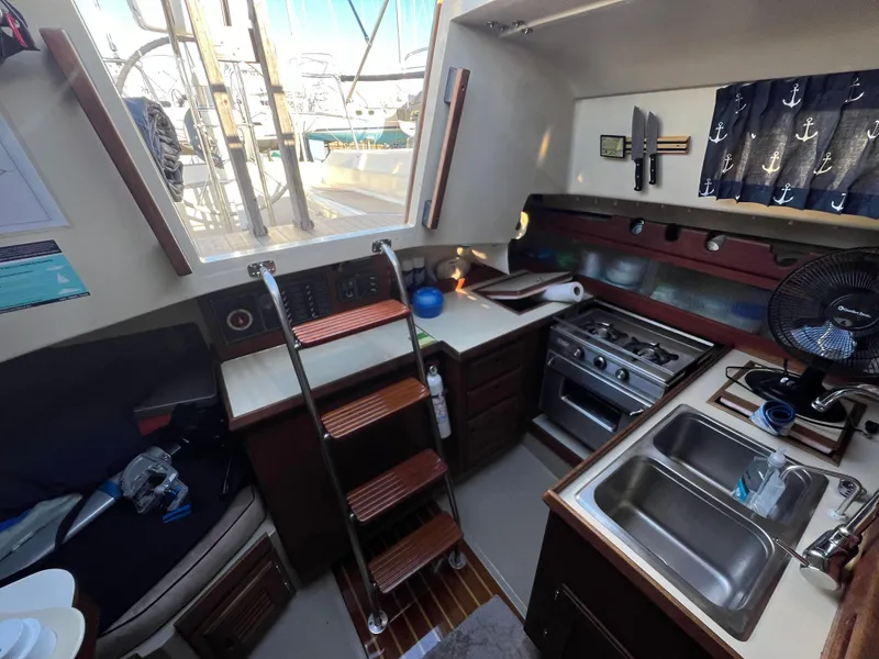 Slide: The Image of Interior of 1983 O'Day 34 sailboat with kitchen, stove, and sink. - 19