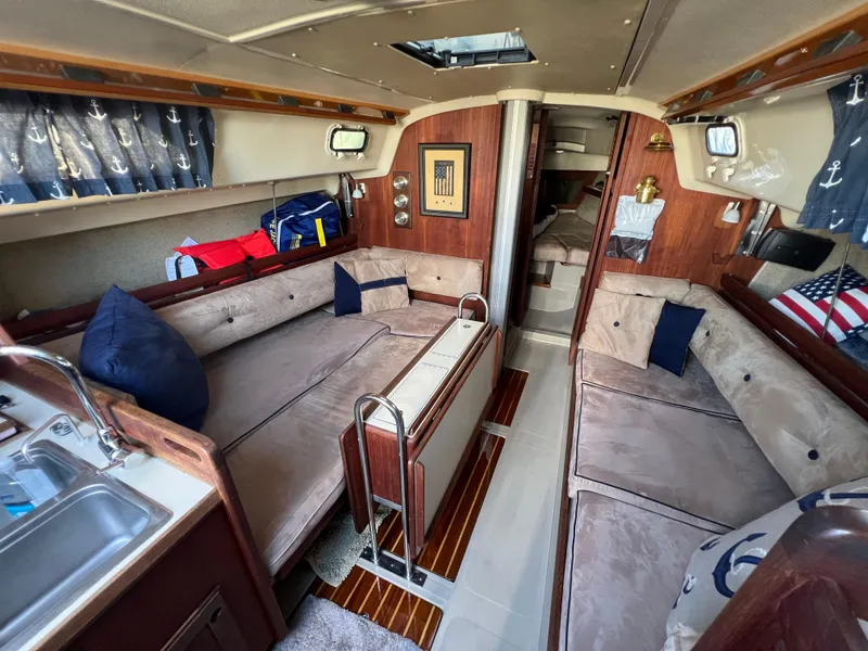 Slide: The Image of Interior of 1983 O'Day 34 sailboat with cozy seating and nautical decor. - 23