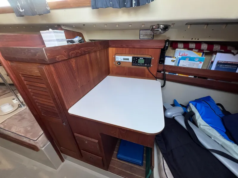Slide: The Image of 1983 O'Day 34 sailboat interior with wooden cabinetry and storage area. - 25
