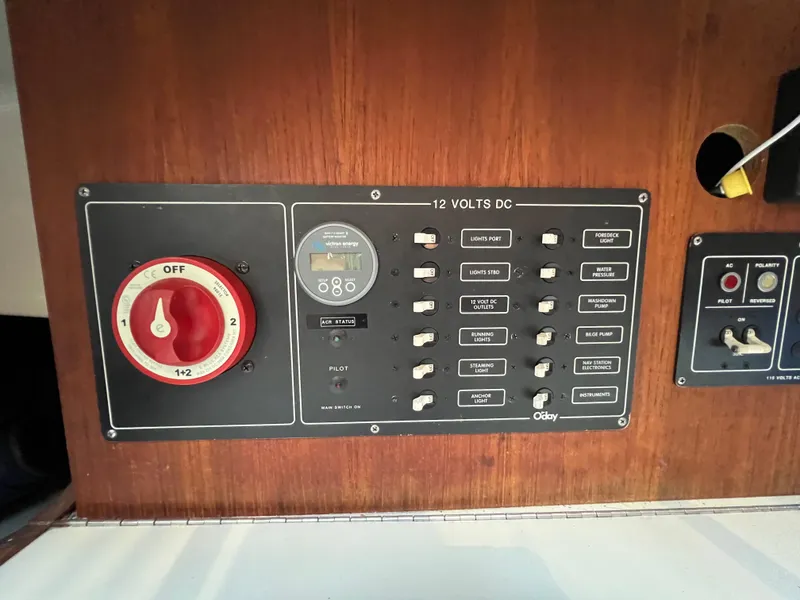 Slide: The Image of 1983 O'Day 34 sailboat electrical panel with switches and voltage meter. - 28