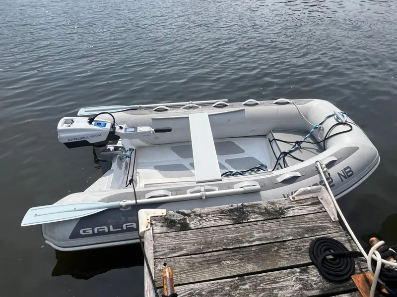 Slide: The Image of Inflatable boat with ePropulsion motor docked on calm water. - 3