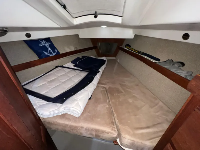 Slide: The Image of 1983 O'Day 34 sailboat cabin interior with cozy bedding and nautical decor. - 31