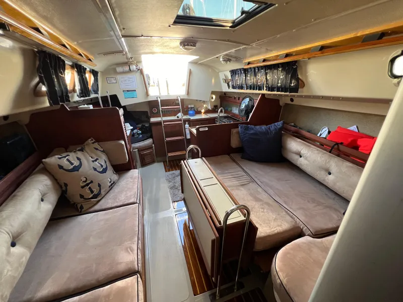 Slide: The Image of Interior of 1983 O'Day 34 sailboat with cozy seating and nautical decor. - 33